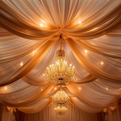 Elegant draped ceiling with chandeliers in warm tones.