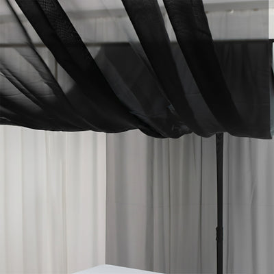 Black sheer canopy draping elegantly over a neutral backdrop.