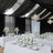 Elegant wedding reception with white floral decor and chandeliers.