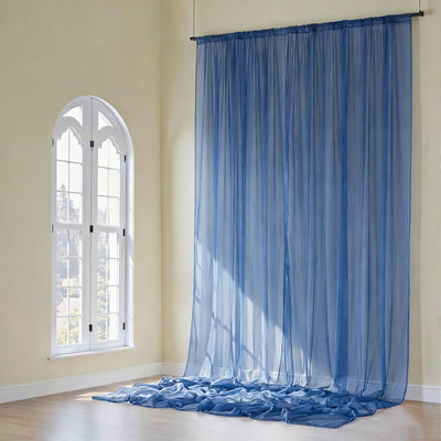 Sheer blue curtains draped elegantly in a sunlit room.