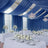 Elegant wedding reception setup with blue drapes and floral centerpieces.
