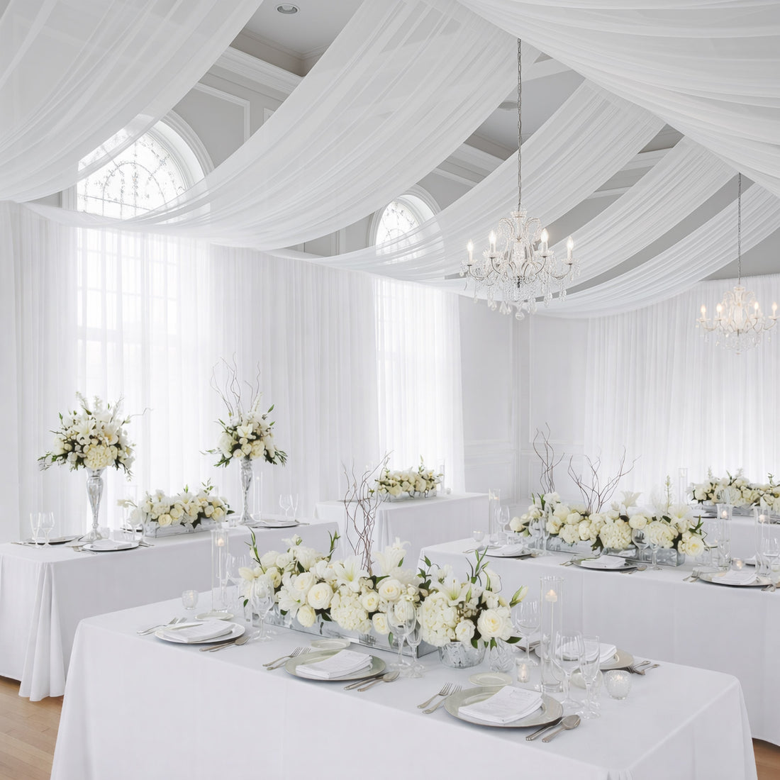 Elegant white floral arrangements in a beautifully decorated event space.