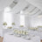 Elegant white floral arrangements in a beautifully decorated event space.