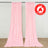 Pink flame retardant curtain panels hanging on a rod, indoor backdrop display