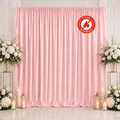 Pink flame retardant backdrop with floral arrangements and candles