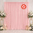 Pink flame retardant backdrop with floral arrangements and candles