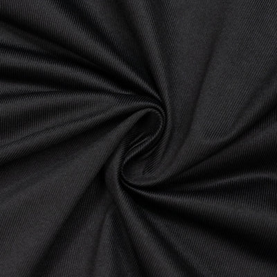 Black ribbed fabric texture with soft swirl folds close-up#whtbkgd