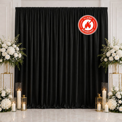 Black flame retardant curtain backdrop with white floral wedding decor and candles