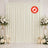 Elegant ivory wedding backdrop with white floral arrangements and candles, flame retardant