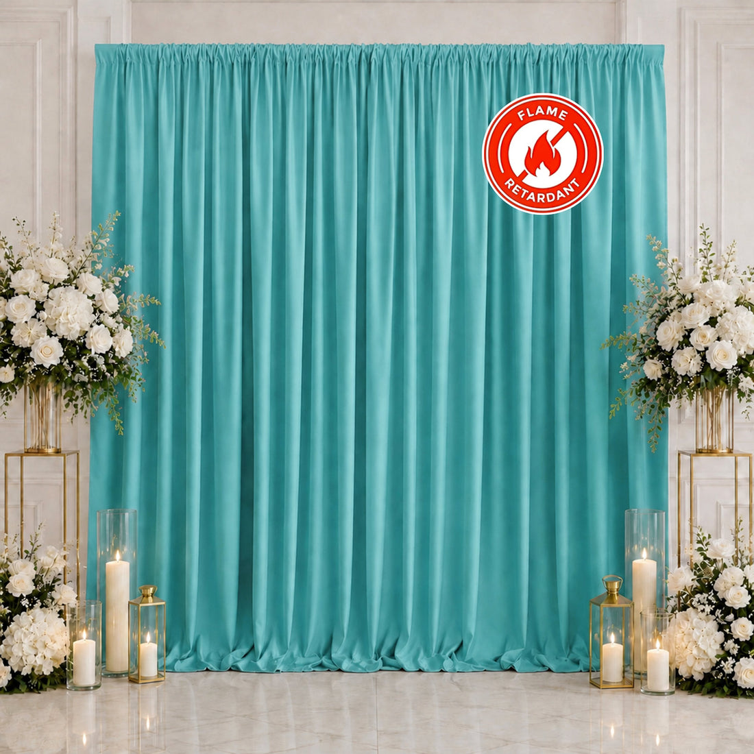 Turquoise event backdrop with white floral arrangements and candles