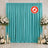 Turquoise event backdrop with white floral arrangements and candles