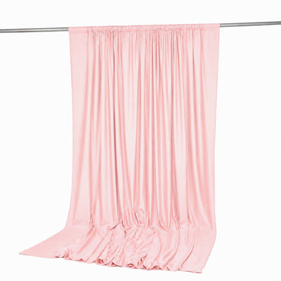 Light pink satin curtain draped on a rod against a white background