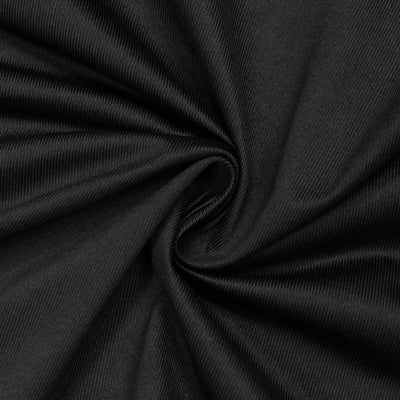 Black ribbed fabric texture with spiral folds close-up
