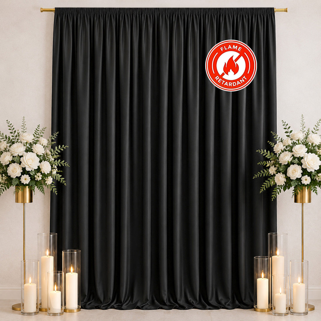Black flame-retardant curtain backdrop with white floral candle arrangement