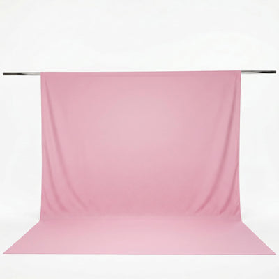 Pink seamless fabric backdrop on hanging crossbar for photography studio#whtbkgd