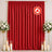 Red fire-retardant curtain backdrop with floral stands and candles