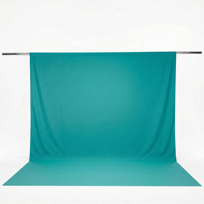 Turquoise photography backdrop with seamless floor and hanging support rod#whtbkgd