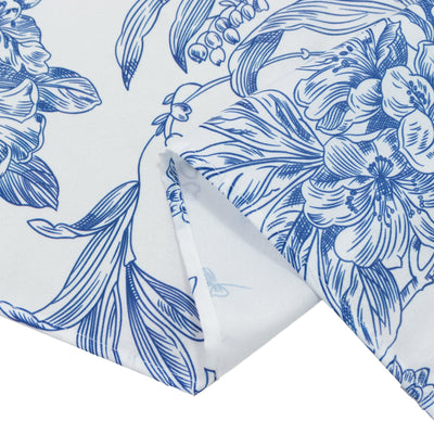 Blue floral patterned fabric corner close-up texture detail.