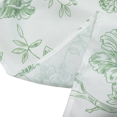 Green floral-patterned fabric corner with detailed print.