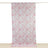 Pink floral patterned fabric hanging on a curtain rod.