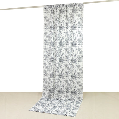 Floral patterned fabric hanging vertically against a plain background