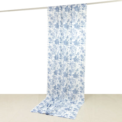 Blue floral patterned fabric hanging on a white backdrop