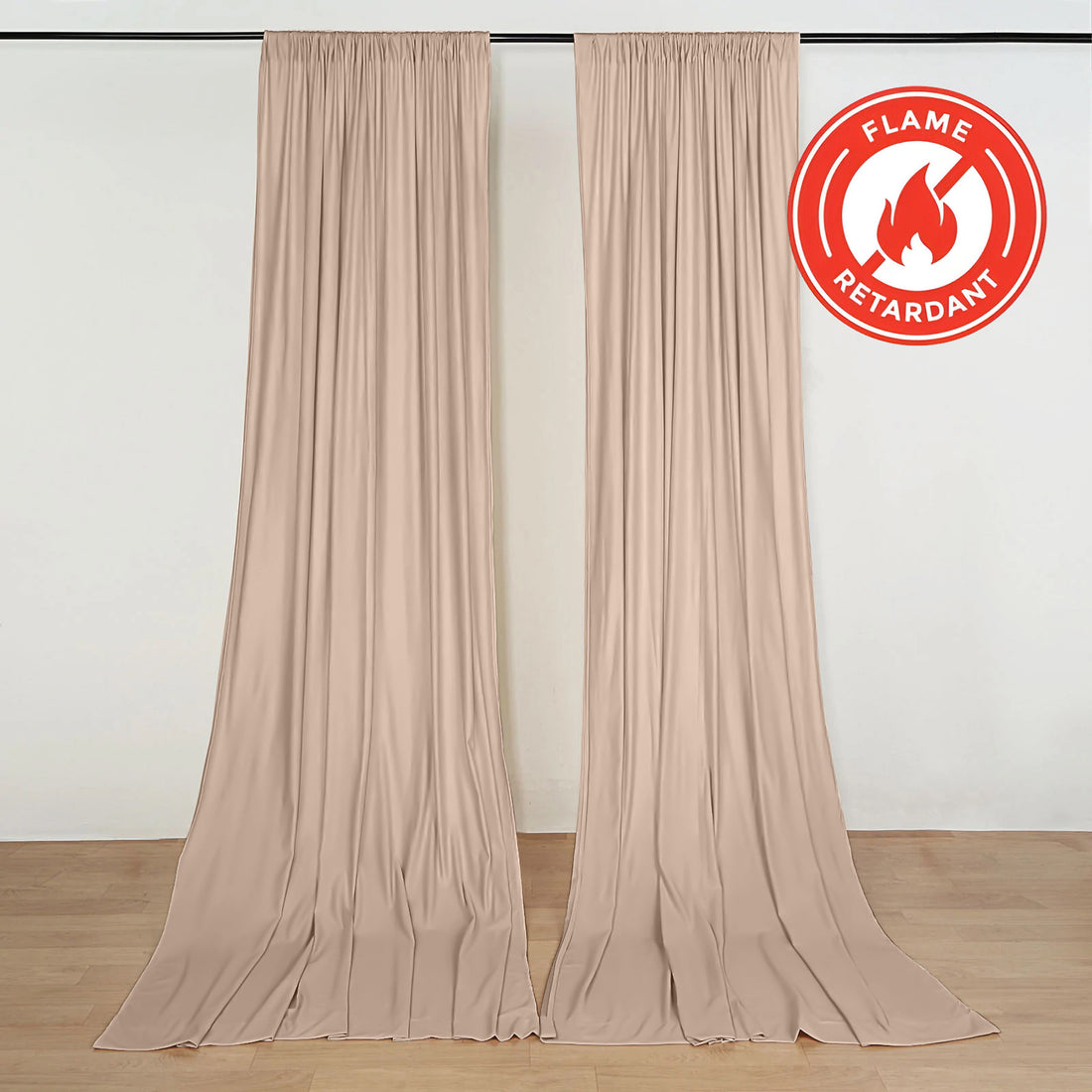 Beige flame retardant curtains hanging on a wall with floor-length drape
