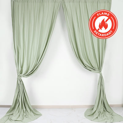 Flame retardant green curtains draped elegantly in a studio setting.