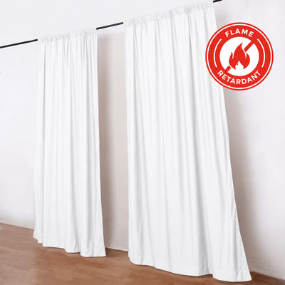 White flame-retardant curtains hanging on a black rod in a bright room