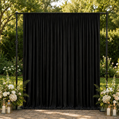 Black wedding backdrop curtain with floral lantern decor in garden setting