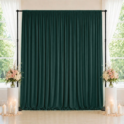 Elegant dark green wedding backdrop with floral arrangements and candles