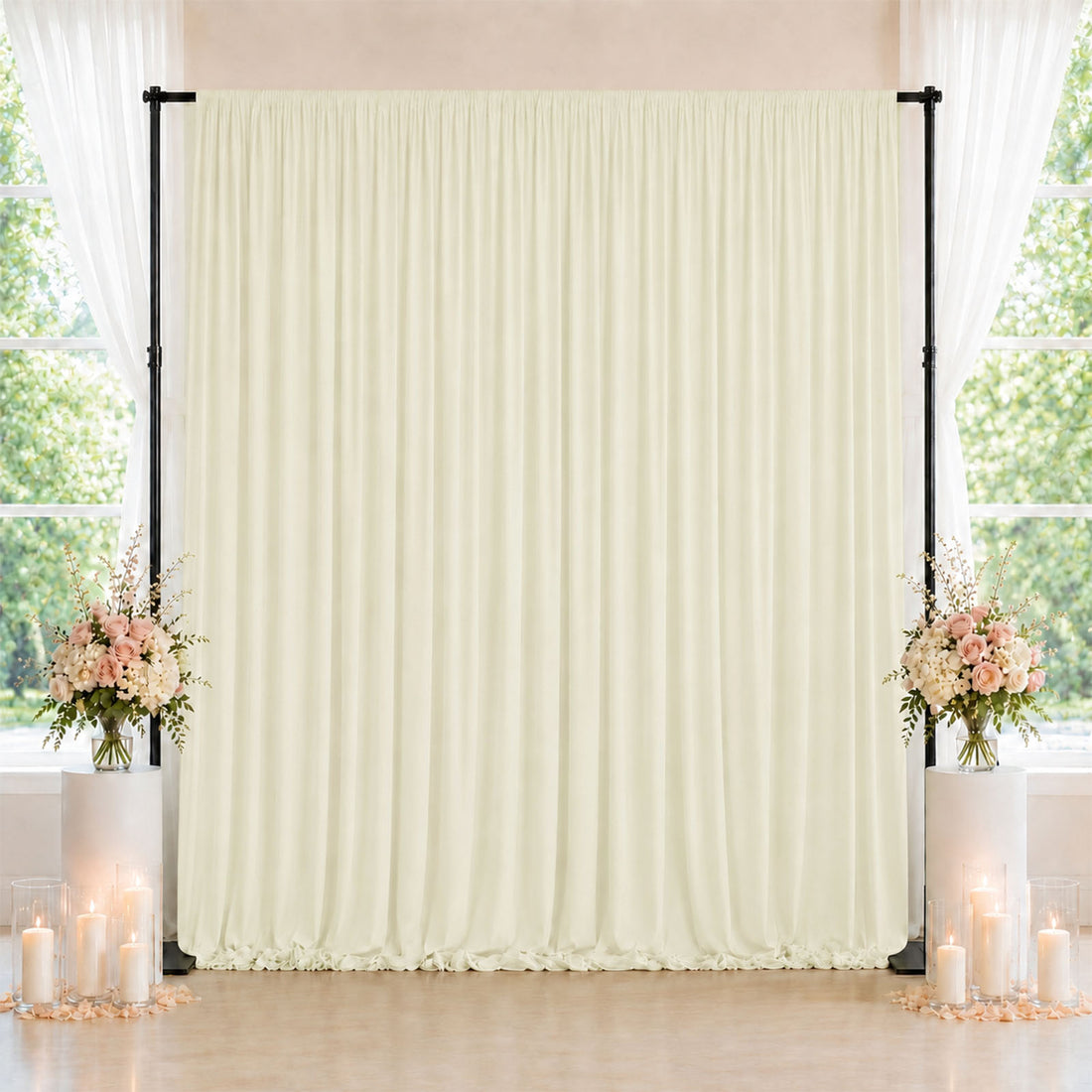 Elegant cream wedding backdrop with floral arrangements and candle decor