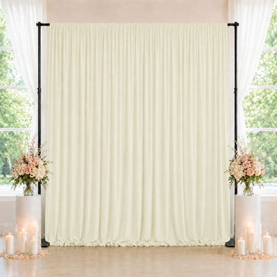Elegant cream wedding backdrop with floral arrangements and candle decor