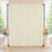 Elegant cream wedding backdrop with floral arrangements and candle decor