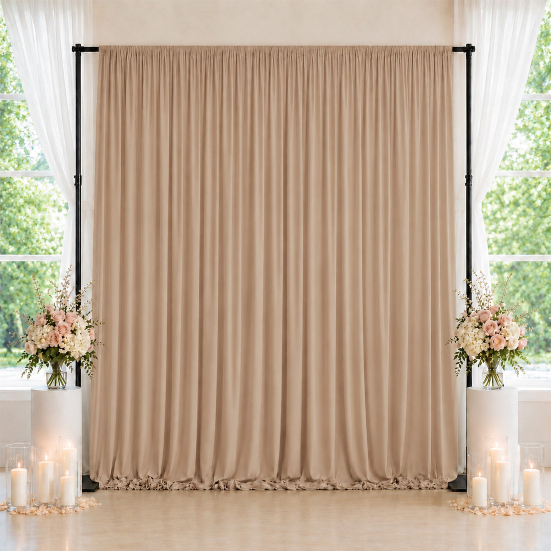 Elegant beige wedding backdrop with floral arrangements and candles