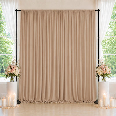 Elegant beige wedding backdrop with floral arrangements and candles