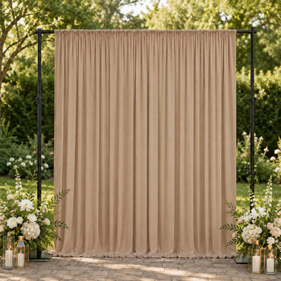 Elegant beige wedding backdrop curtain with floral arrangements outdoors