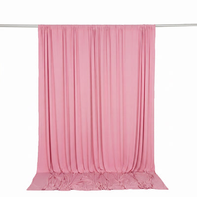 Pink draped fabric backdrop curtain on a rod, studio photography background