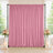 Pink wedding backdrop curtain with floral arrangements and candle decor