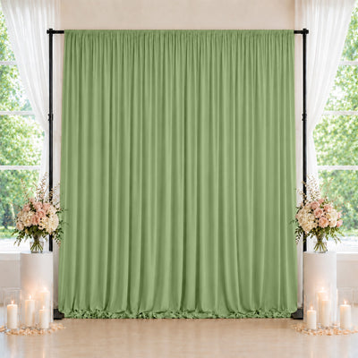 Green wedding backdrop curtain with floral arrangements and candles