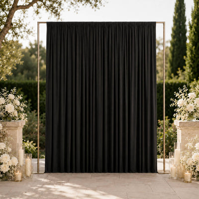 Black wedding backdrop with gold frame and white floral aisle decor outdoors