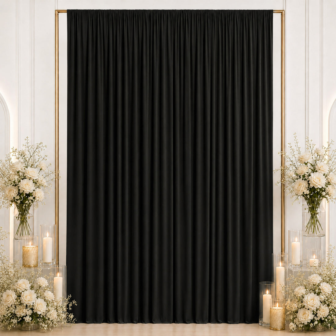 Elegant black curtain backdrop with white roses and candles for event decor