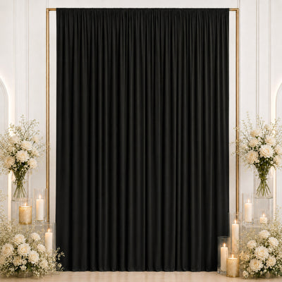 Elegant black curtain backdrop with white roses and candles for event decor