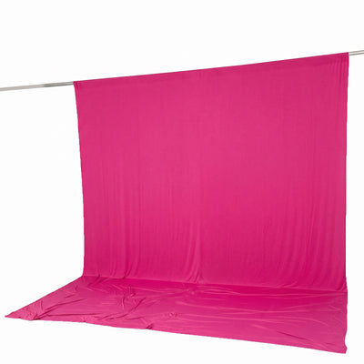 Bright pink seamless fabric backdrop on a hanging rod with floor sweep