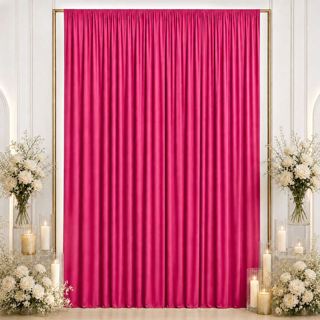 Hot pink pleated curtain backdrop with white floral arrangements and candles