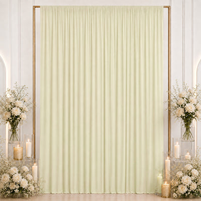 Elegant cream curtain backdrop with floral arrangements and candles