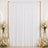 Elegant white wedding backdrop with gold frame, candles, and floral arrangements