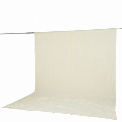 Cream backdrop curtain on a rod with draped floor fabric, studio background