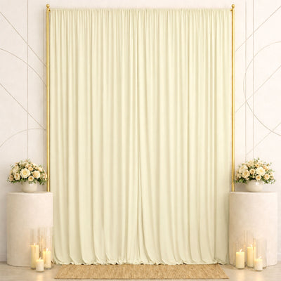 Elegant cream wedding backdrop with gold frame, floral arrangements, and candles