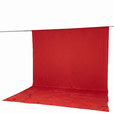 Red seamless photography backdrop with floor and hanging rod